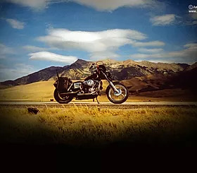 Motorcycle with grassy plains and mountains in the background