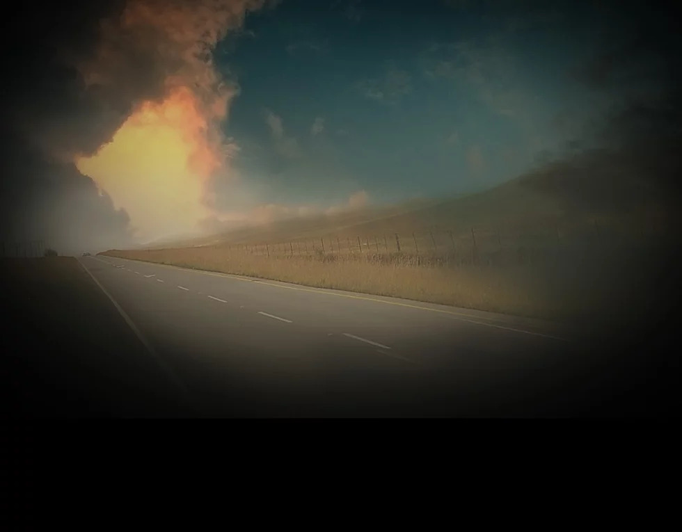 Open road with green pastures in the background