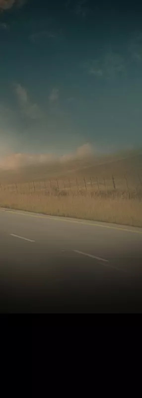 Open road with green pastures in the background